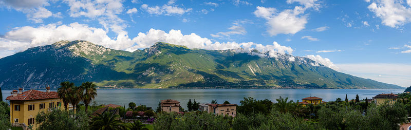 Scenic view of sea and mountains against sky