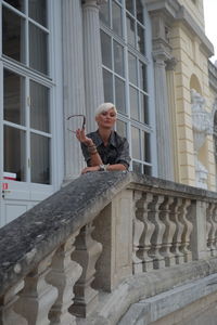 Full length of woman standing against building