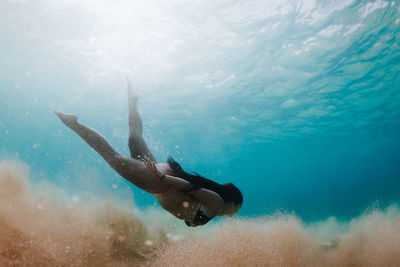 Woman wearing bikini while swimming in sea