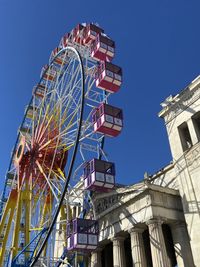 Low angle view of ferris wheel against clear sky