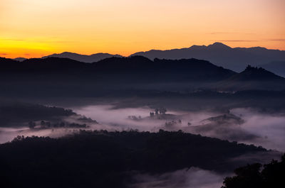 Scenic view of silhouette mountains against sky during sunset