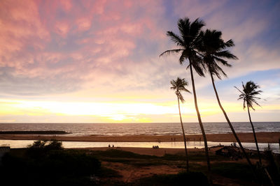 Scenic view of beach against sky during sunset