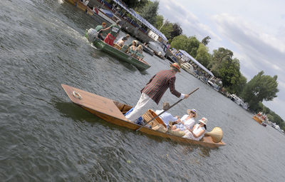 People sitting on boat in river