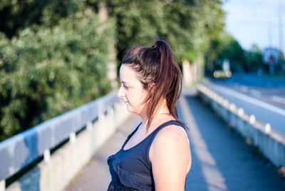 Woman standing on bridge in city