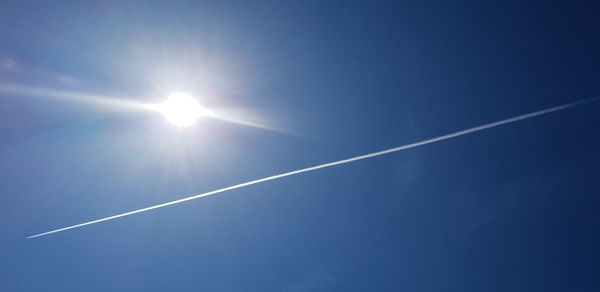 Low angle view of vapor trails in sky