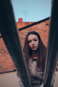 Portrait of woman standing against wall