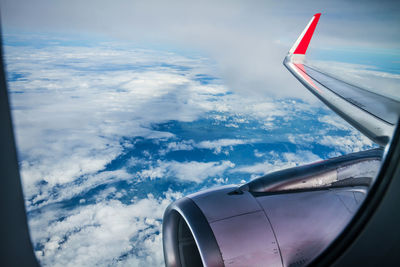 Aerial view of airplane flying in sky