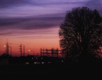 Silhouette trees against sky at night