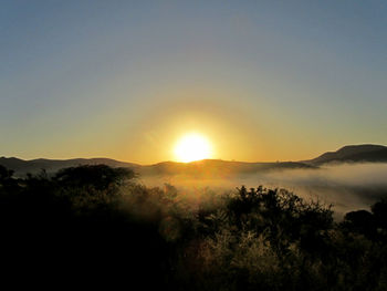 Scenic view of silhouette mountains against sky during sunset