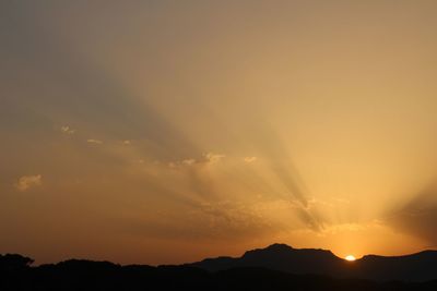 Scenic view of silhouette mountains against sky during sunset