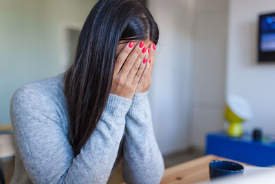 Portrait of woman covering face