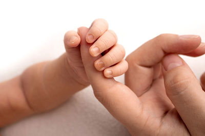 Close-up of hands holding baby hand