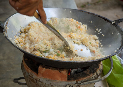 Cropped hand preparing food