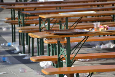 Close-up of wooden table in row