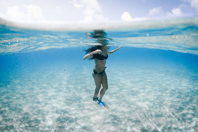 Woman wearing bikini while swimming in sea