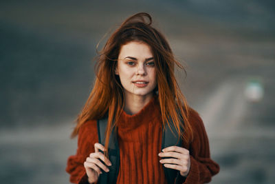 Portrait of a beautiful young woman standing outdoors