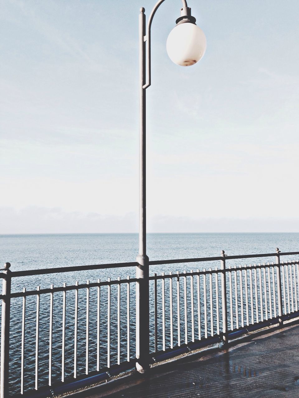 clear sky, low angle view, copy space, built structure, architecture, street light, lighting equipment, building exterior, sky, day, tower, no people, technology, outdoors, modern, connection, nature, horizon over water, city, blue