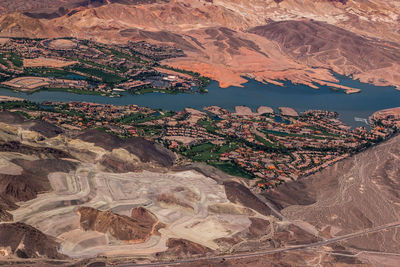 High angle view of houses and mountains by river