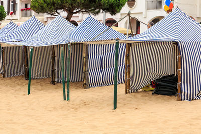 Hooded chairs on beach chair outside building