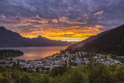 Scenic view of river and mountains against cloudy sky