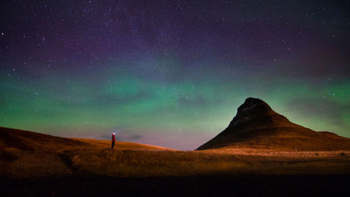 Scenic view of aurora borealis above kirkjufell mountain