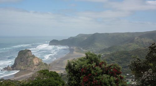 Scenic view of sea and mountains against sky