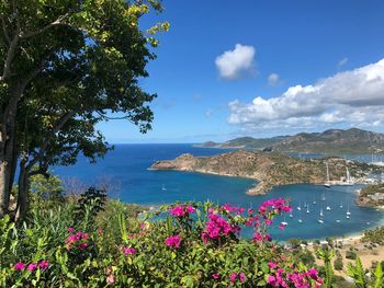 Scenic view of sea and mountains against blue sky