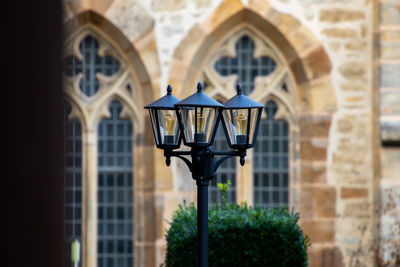 Low angle view of street light against building