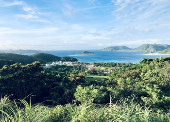 Scenic view of sea and trees against sky