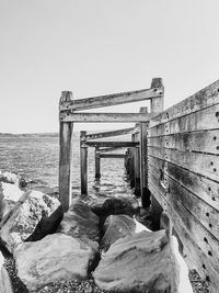 Pier over sea against clear sky