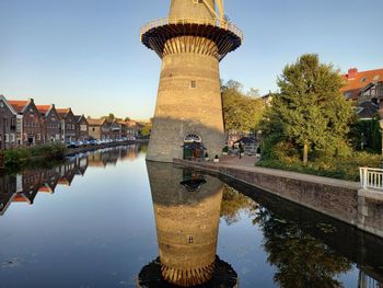 Reflection of buildings in river against sky