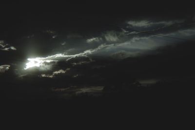 Low angle view of storm clouds over dark sky