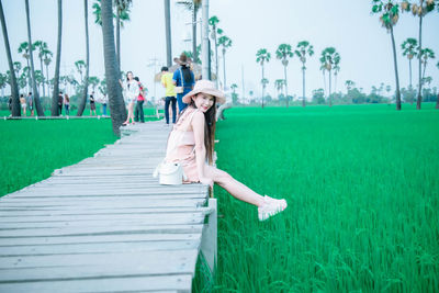 Portrait of woman sitting on field