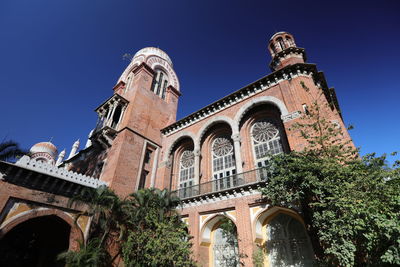 Low angle view of historic building against clear blue sky