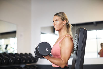 A woman strength training in the gym.