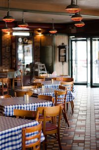 Empty chairs and tables in restaurant