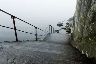 Bridge over sea against clear sky