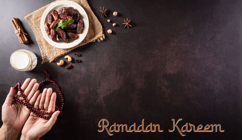 High angle view of hand holding food on table