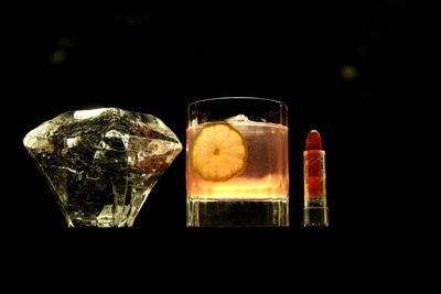 Close-up of beer in glass against black background