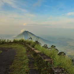 Scenic view of mountains against cloudy sky