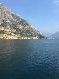 Scenic view of sea and mountains against sky