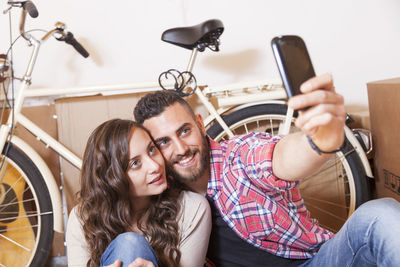 Portrait of smiling friends using mobile phone