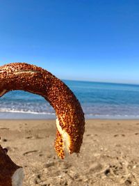 Turkish bagel at beach against clear sky