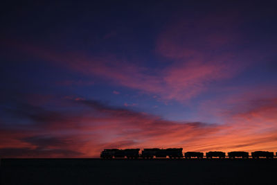 Silhouette buildings against sky during sunset