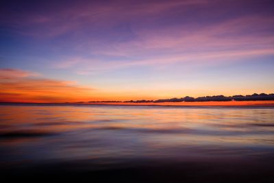 Scenic view of sea against romantic sky at sunset