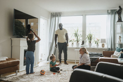 Happy family having fun playing games together at home