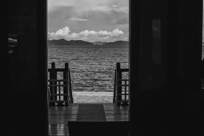 Scenic view of sea seen through open door