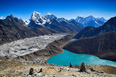 Scenic view of snowcapped mountains against clear blue sky