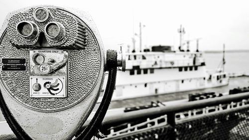 Close-up of coin-operated binoculars against sky