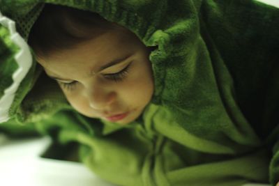 High angle view of boy in costume sleeping indoors